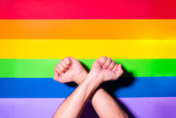 Hand fist with lgbt flag background. Lgbt pride concept.