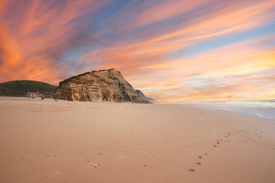 Beautiful sandy ocean beach and cliff at the sunset. Panorama atlantic