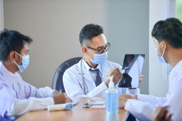 Group of doctors discussing work in office hospital