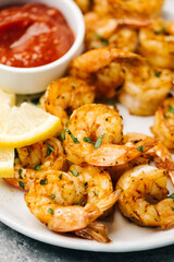 Platter of golden spicy air fried shrimp with cocktail sacue