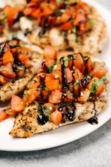 Grilled bruschetta chicken breast with balsamic reduction