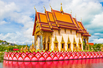 Colorful architecture lake and statues Wat Plai Laem temple Thailand.