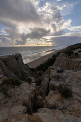 Fototapeta na wymiar unas vistas de la bella playa de Mazagon, situada en la provincia de Huelva, España. Con sus acantilados , pinos, dunas , vegetacion verde y un cielo con nubes. Atardeceres preciosos