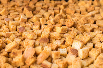 Square-shaped bread crumbs. Oven-fried golden brown bread crumbs. Background.