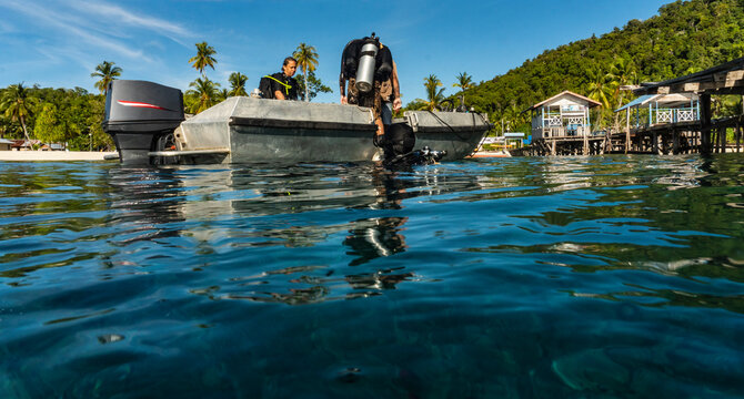 divers finishing dive and emerging from the ocean at Raja Ampat