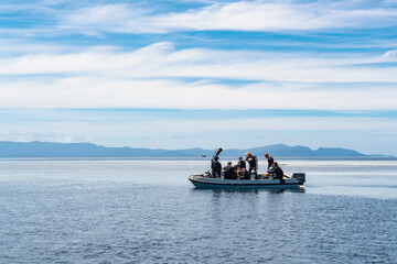 divers heading to dive spot on dingy boat in Raja Ampat