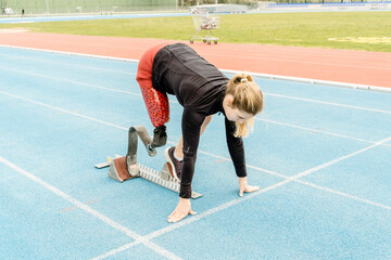 Side view of female athlete with prosthetic leg