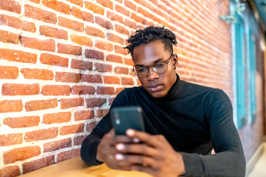 young african man working from his smartphone