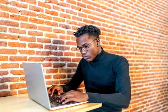 young african man working from his laptop