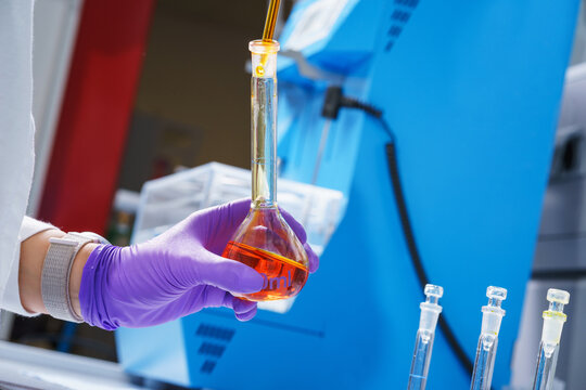 Laboratory assistant in a scientific laboratory holds a test tube.