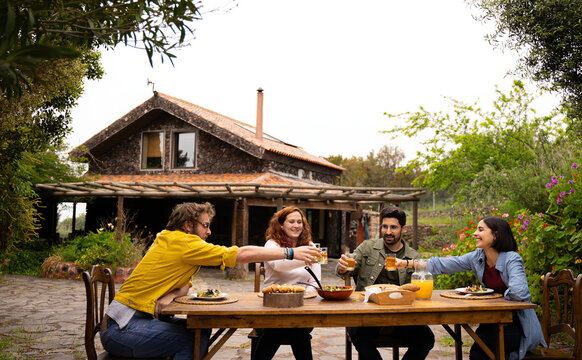 friends spending the day in a country house while eating and having fu