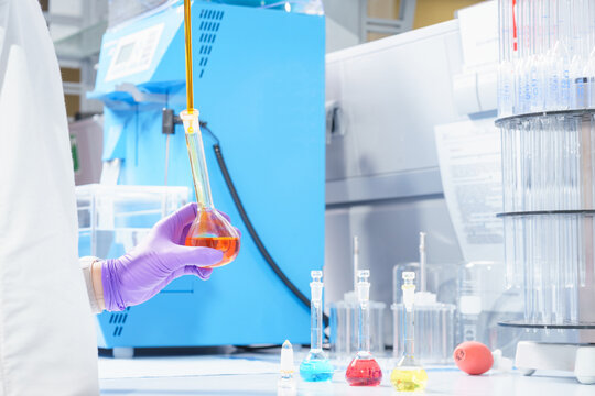 Laboratory assistant in a scientific laboratory holds a test tube.