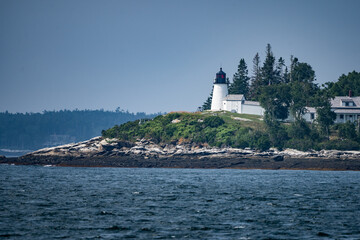 Fototapeta na wymiar Burnt Island Lighthouse with blue sky background in Boothbay Harbor, Maine