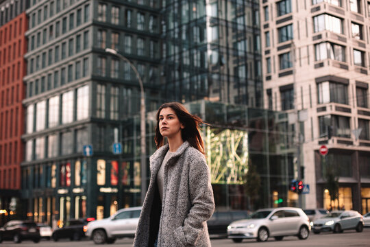 Thoughtful young woman walking on street in city - Powered by Adobe