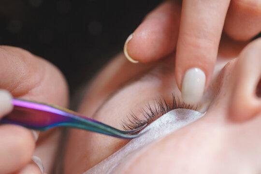 Aesthetic medicine: eyelash extension procedure for young woman