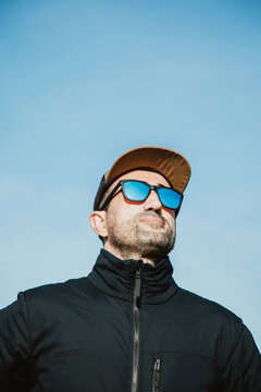 Man with sunglasses and cap on a sunny day