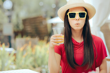 Summer Woman Wearing Sun Hat and Sunglasses Drinking Orange Juice