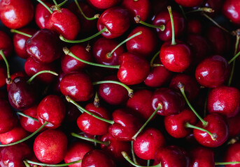 Close up of a bunch of bright red cherries shot from above.