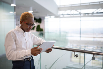 Black businesswoman using tablet in workplace