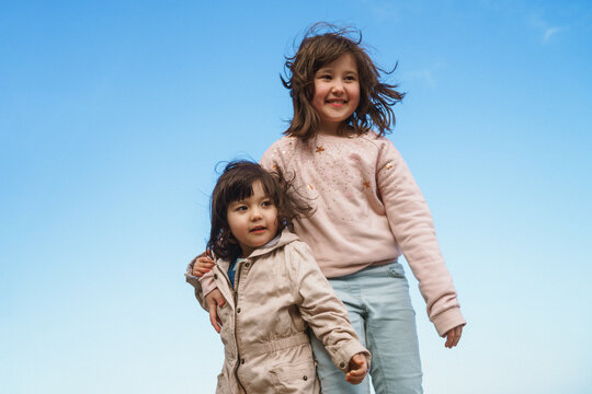 two girl against blue sky