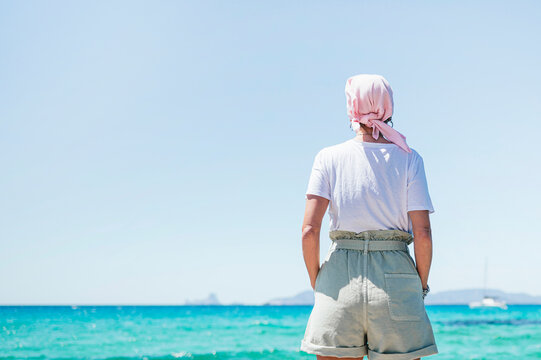 Woman with pink headscarf, has cancer