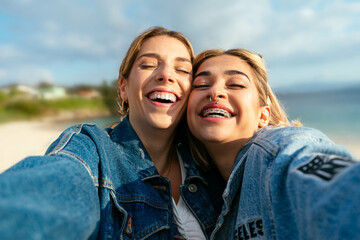 Two beautiful smiling female friends taking a selfie