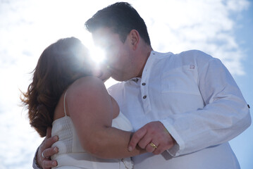 Couple in love, Hispanic man with Latin woman, walking on the beach.