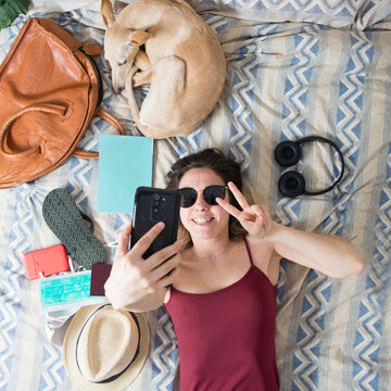 woman packing suitcase for summer vacation