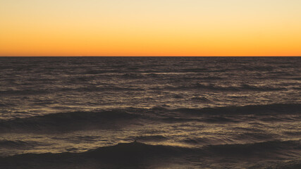 Golden sunset over sea. clear sky with the horizon