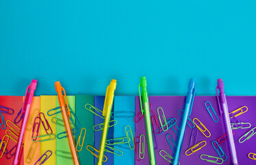 Background with Rainbow Colored School or Office Supplies