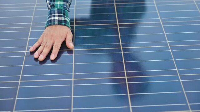 Close up of engineer hand touching and moving on sun solar cells panel power and alternative energy in construction site. Clean and renewable energy ecology to environmental technology in outdoors. 