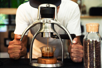 Professional Asian baristas prepare coffee using a coffee press and drip kettle. Another option for brewing coffee coffee shop concept