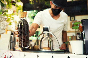 Professional Asian baristas prepare coffee using a coffee press and drip kettle. Another option for brewing coffee coffee shop concept
