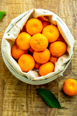 A basket tangerines against wooden
 background