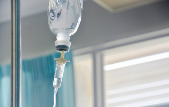 Normal saline solution (NSS.) bag and infusion pump for patient in the patient room at the hospital, copy space