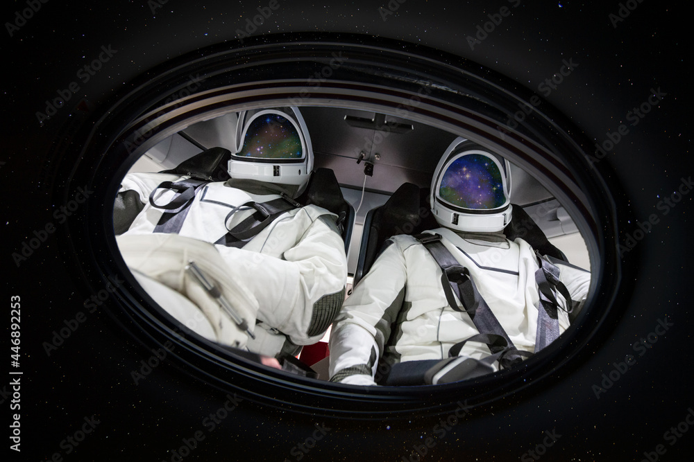 Poster two astronauts in porthole in space. elements of this image furnished by nasa.