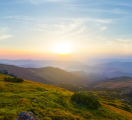 Fototapeta premium green mountain valley at the sunrise, travel mountain background
