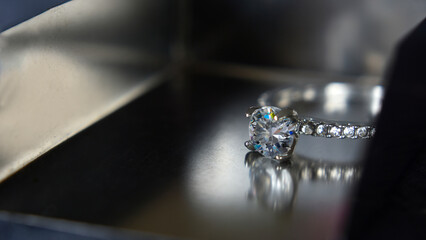 The wedding ring is a white gold ring decorated with diamonds.