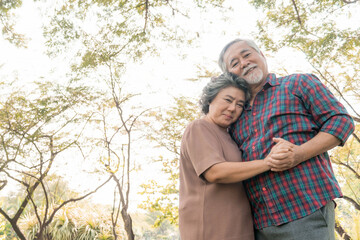 Fototapeta premium Happy love Elderly senior couple hugging smile face , Senior couple old man and senior woman relaxing hug in park