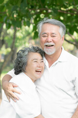 Happy love Elderly senior couple hugging smile face , Senior couple old man and senior woman relaxing hug in park