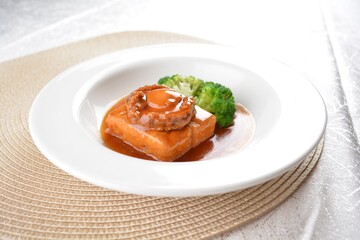 braised whole big abalone with bean curd tofu and broccoli in chef premium oyster sauce in white...