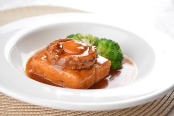 braised whole big abalone with bean curd tofu and broccoli in chef premium oyster sauce in white background asian halal seafood menu