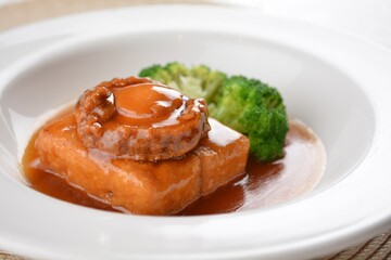 braised whole big abalone with bean curd tofu and broccoli in chef premium oyster sauce in white...