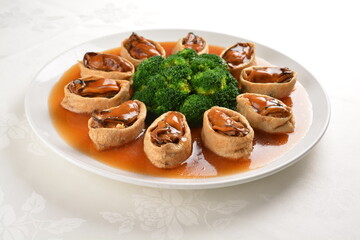 braised fresh oyster in bean curd tofu skin and broccoli with chef special oyster sauce in white background asian halal seafood menu