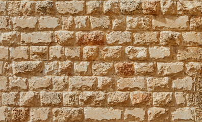 Background of the stone wall of the castle made of stones of different shapes and sizes and textures