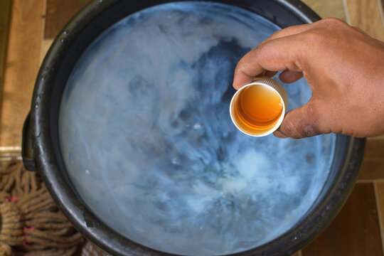 Mixing antiseptic liquid with water. It helps kill viruses, bacteria and germs around the home. Coronavirus protection.