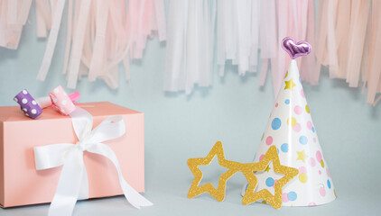 Birthday composition: hats, gifts and pipes. Image with selective focus