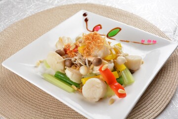 stir fried scallop with mixed vegetable and macadamia nut in oyster sauce in white background asian halal seafood menu