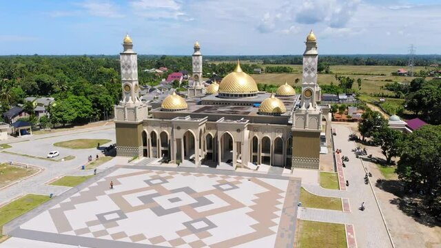 Aerial video of the Baitul Ghafur Grand Mosque in southwest Aceh seen directly from the front with the drone moving to the left