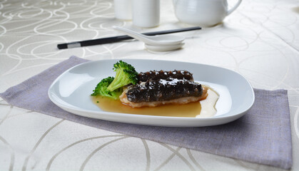 braised cook whole sea cucumber with vegetable in special chef oyster thick sauce in white background asian halal seafood menu